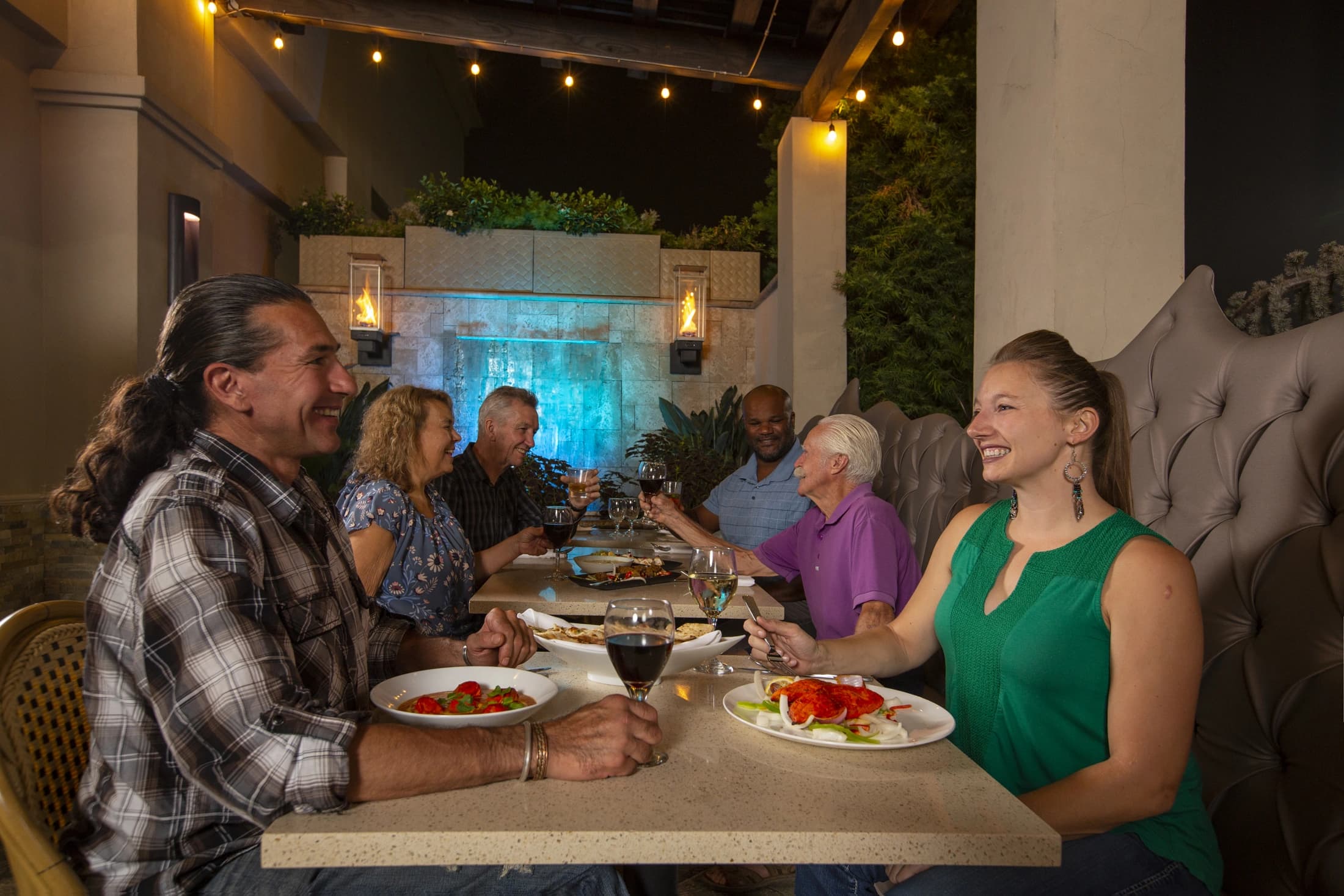 A group of guests celebrating together on the India Oven patio